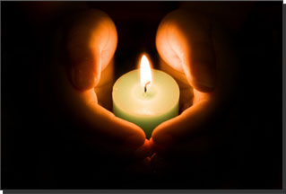 Hands holding a candle